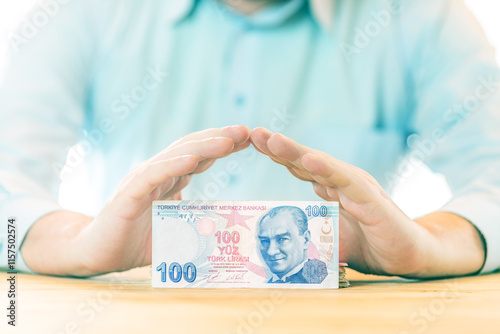 Saving money. Accounting, business, budget and finance concept. Male hands above one hundred turkish Lira banknote photo