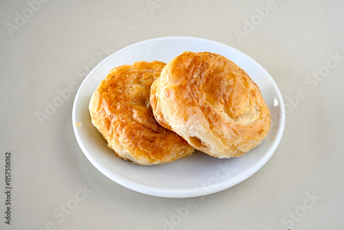 Turkish pastry product , tasty pogaca. Simit, gevrek. Turkish Pastries; peynirli, patatesli, kasarli pogaca, borek, acma, ay coregi at patisserie showcase. Boyoz peynirli acar.  photo