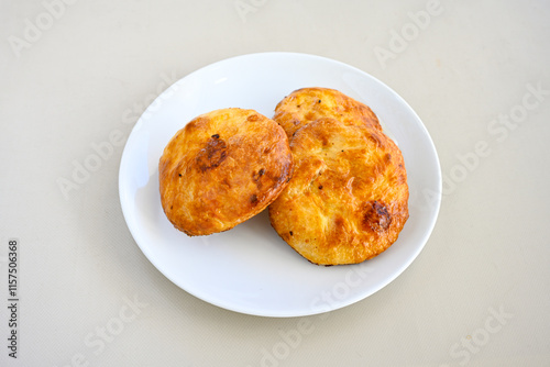 Turkish pastry product , tasty pogaca. Simit, gevrek. Turkish Pastries; peynirli, patatesli, kasarli pogaca, borek, acma, ay coregi at patisserie showcase. Boyoz peynirli acar.  photo