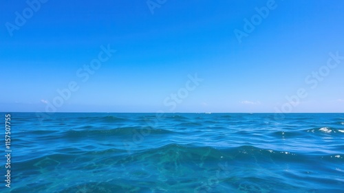 Serene Blue Ocean Waves Under a Clear Sky on a Sunny Day, Capturing the Tranquility of Nature and the Beauty of Coastal Landscapes