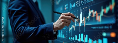 Businessman analyses financial data on large screen. Points at growth graph with pen. Business planning, investment strategy visible. Modern digital accounting shown. Data driven decision making for photo