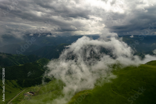 Mountains in the clouds, low clouds in a mountain valley. Landscape and nature of the North Caucasus