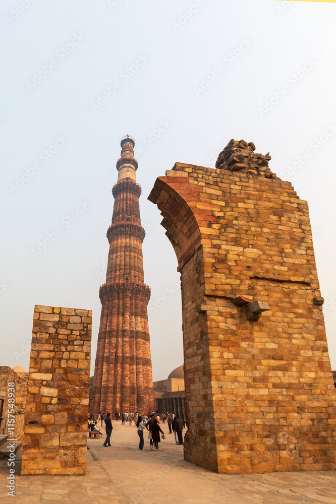 Fototapeta premium New Delhi, India December 20, 2024: Aibak’s 72.5 mts. tall - Qutb Minar happens to be the tallest minaret in the world built of bricks, bears the rich testimony of early Afghan architecture. 