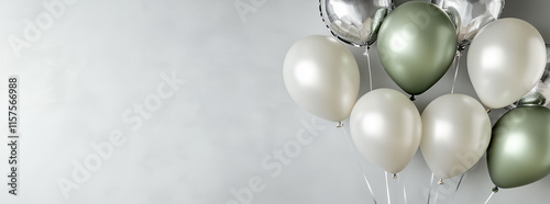 Photo of soft olive and silver balloons on a gray background with copy space