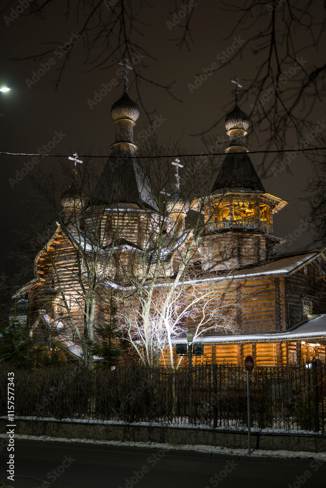 Φωτογραφία Wooden church in winter night Moscow by the light of street lamps