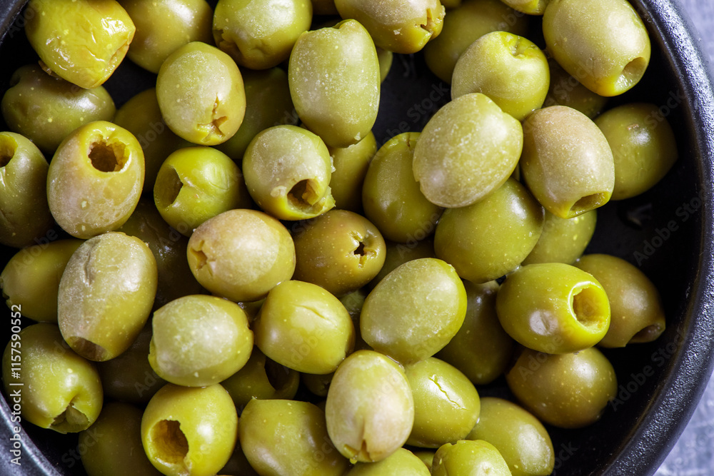 Pitted and marinated green olives in bowl Pitted and marinated green olives in bowl