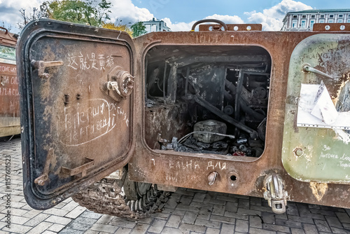 Open hatch of a destroyed Russian military vehicle displayed at Mykhailivska Square in Kyiv. Interior reflects the severe damage sustained during Ukraine invasion. Kyiv, Ukraine - October 27, 2023 photo