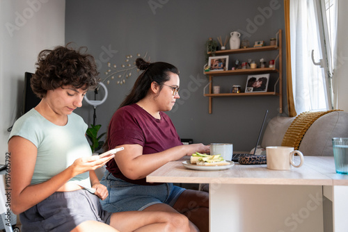 Relaxed morning routine of a young lesbian couple in cozy home setting photo