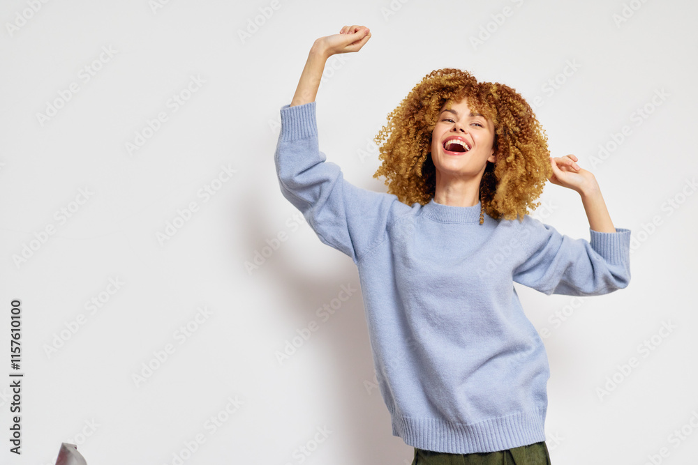 Happy woman celebrating joyfully in a soft blue sweater against a minimalist white background, radiating positivity and carefree vibes Expressing happiness and energy Happy woman celebrating joyfully in a soft blue sweater against a minimalist white background, radiating positivity and carefree vibes Expressing happiness and energy