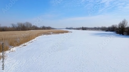 Winter Landscape Over A Frozen River With Clear Blue Sky And Snowy Fields