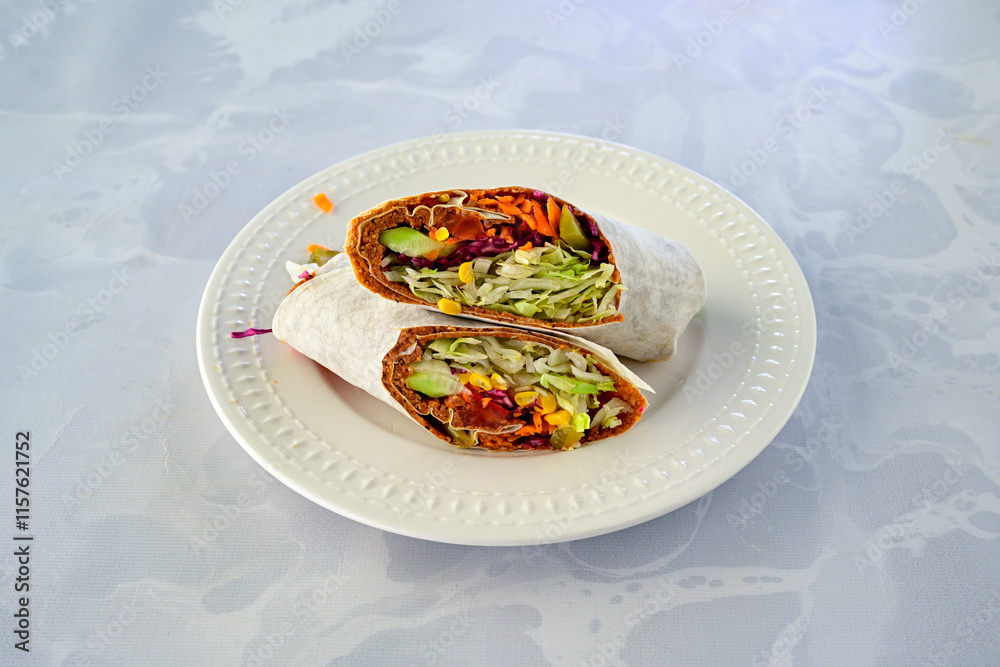 Cig kofte (raw meatball) with lettuce, tomato, pickle and lemon, hot Chee kofta. Turkish local raw food concept.Table scene of assorted take out or delivery foods. Doritoslu duble cig kofte durum. Cig kofte (raw meatball) with lettuce, tomato, pickle and lemon, hot Chee kofta. Turkish local raw food concept.Table scene of assorted take out or delivery foods. Doritoslu duble cig kofte durum.