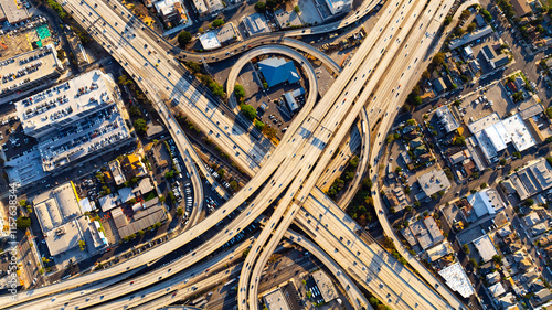 Lively traffic on the highways, loops and freeways in Los Angeles downtown. Approaching famous interchange in metropolis midtown.