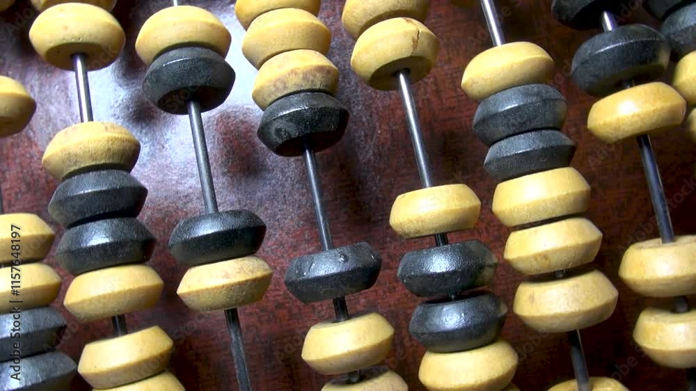 Old wooden abacus on wooden surface close up