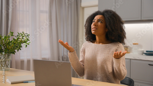 Annoyed angry woman African American businesswoman freelancer online working laptop at home kitchen stressed displeased mad female girl scream crazy with noise sound close ears disturb noisy at house
