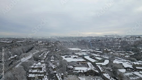 Aerial footage of the Milnsbridge district of Huddersfield covered with snow during daytime, England photo