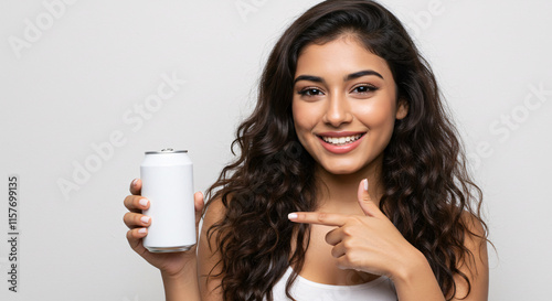 A beautiful girl pointing at a soda can