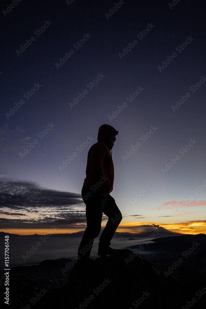Male silhouette against sunrise while hiking Male silhouette against sunrise while hiking