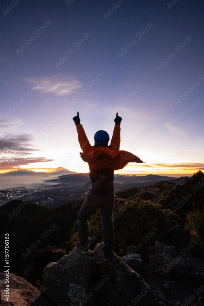 Man celebrating on mountain top at sunrise Man celebrating on mountain top at sunrise