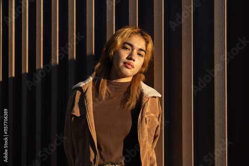 Mixed Race Woman in Warm Glow Against Geometric Backdrop photo