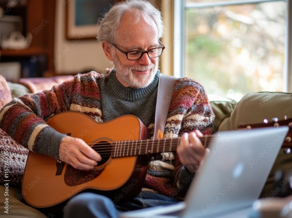 A senior man playing the guitar at home, sitting on his couch with a coffee and laptop nearby. A senior man playing the guitar at home, sitting on his couch with a coffee and laptop nearby.