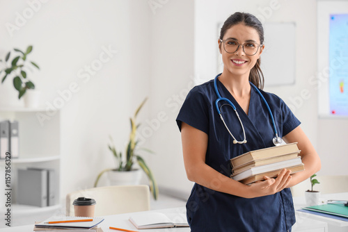 Young female medical student with books and stethoscope in clinic