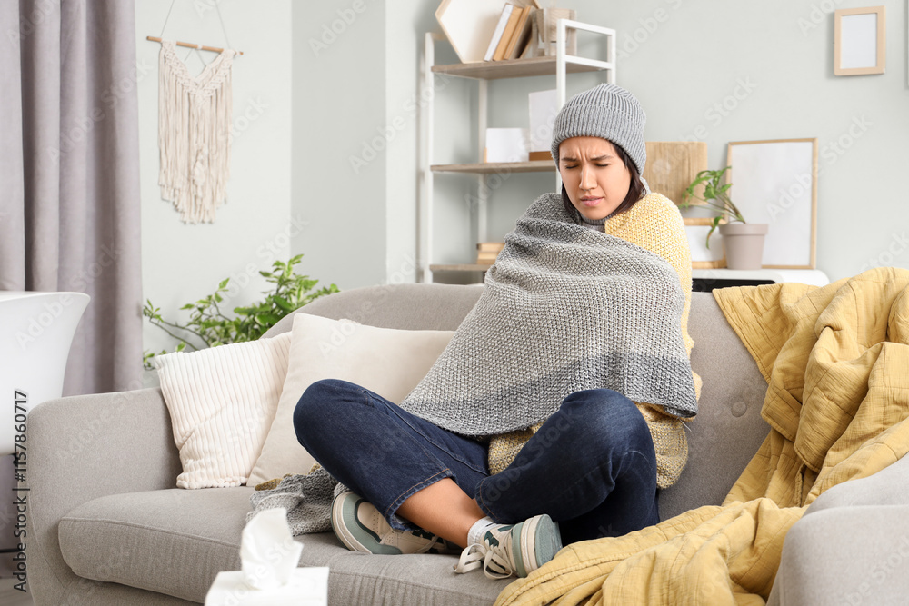 Fototapeta premium Sick young woman sitting on sofa