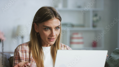 Young shocked freelancer woman working from home office using laptop having video call with client or colleagues feeling surprised by information she received