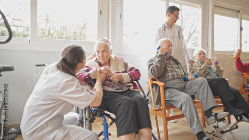 Medical staff assisting seniors in a rehabilitation exercise session in a bright room.