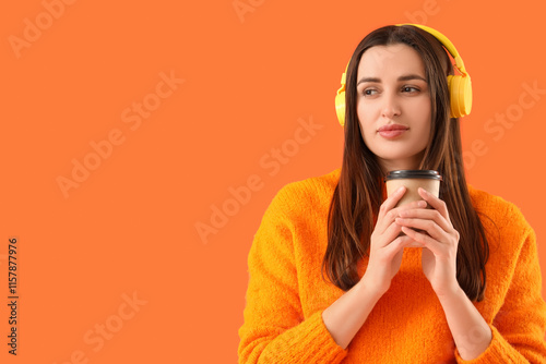 Wondering young woman in headphones with coffee cup on orange background, closeup photo