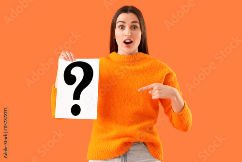 Surprised young woman point...