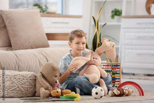Cute little boy with toys s...