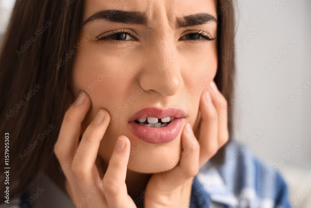 Young woman suffering from toothache at home, closeup Young woman suffering from toothache at home, closeup