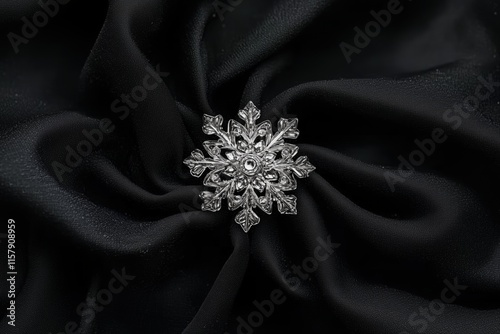 Intricate silver snowflake brooch on black fabric. Elegant jewelry and festive accessory photo