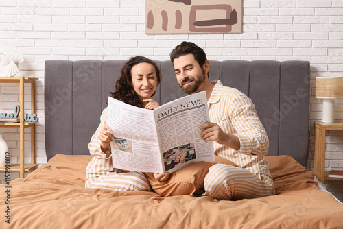 Happy couple in pajamas rea...