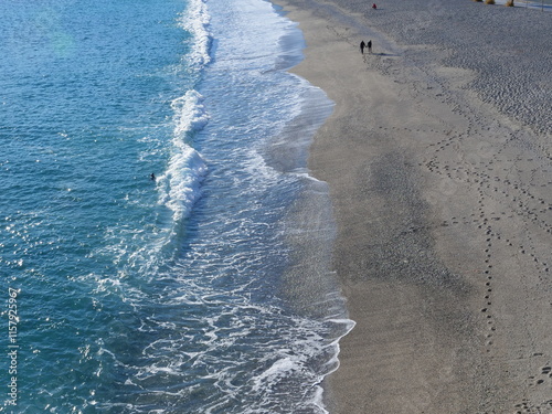 A close-up of a wave breaking on a sand beach. Spotorno, Italy - December 23, 2024.