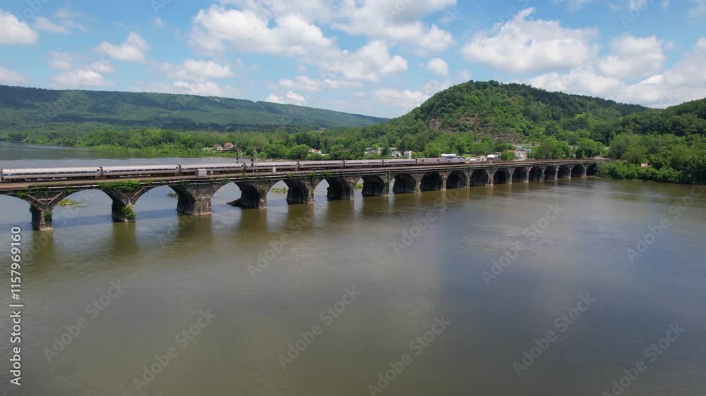 PENNSYLVANIA - 7.11.2024 - Wonderful aerial view following an Amtrak train traveling on the Rockville Bridge over the Susquehanna River. PENNSYLVANIA - 7.11.2024 - Wonderful aerial view following an Amtrak train traveling on the Rockville Bridge over the Susquehanna River.