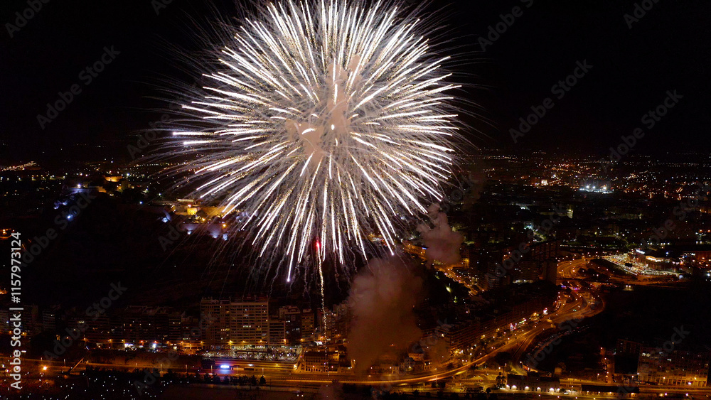 Nocturne aerial view of the fireworks launched in the beach of El Postiguet, in the Mediterranean city of Alicante, Spain. Nocturne aerial view of the fireworks launched in the beach of El Postiguet, in the Mediterranean city of Alicante, Spain.
