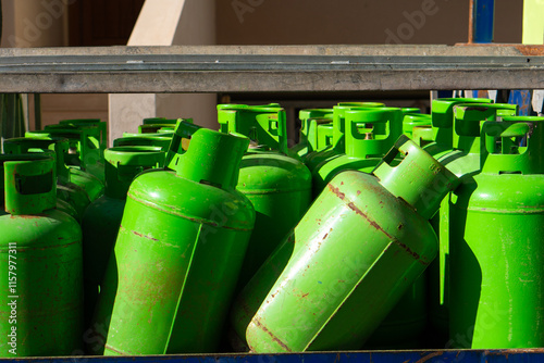 Pickup truck carrying LPG gas, bright green metal bottles with LPG gas background photo