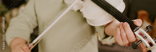 Medium closeup of unrecognizable girl with Down syndrome practicing violin, header for website