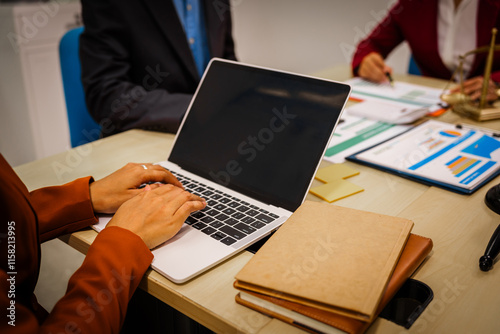 Two male and female lawyers sit at a table in an office, discussing legal matters related to opening a company.They focus on laws, regulations,and collaboration between in-house and business lawyers