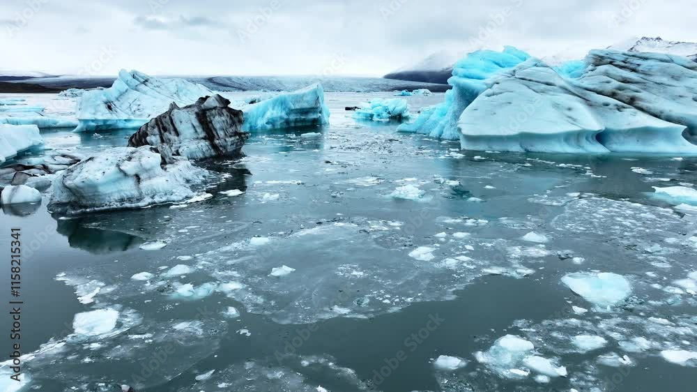Iceberg in the ocean, Huge chunks of blue glacier ice floating on the waves, Arctic nature in Iceland