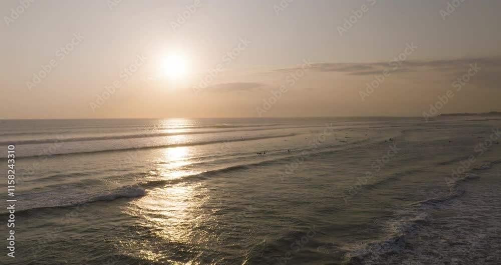 Aerial sunset view of Canggu Beach, Bali, with golden waves and glowing ocean horizon Aerial sunset view of Canggu Beach, Bali, with golden waves and glowing ocean horizon