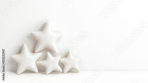 Soft white star shaped cushions arranged on minimalist background create serene atmosphere