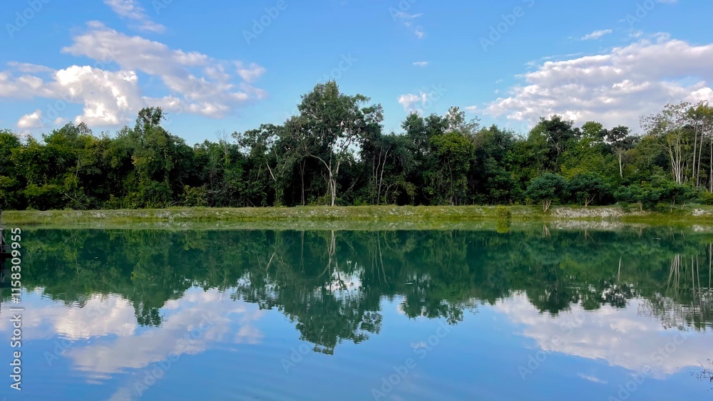 Fototapeta premium Mirror reflection of the landscape shore in the reservoir.