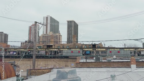 Chicago, USA.Dec,12,2024, Establishing a shot of a neighborhood in downtown Chicago with train transportation. Took at the rooftop on a cloudy day. Took at the rooftop on a cloudy day.