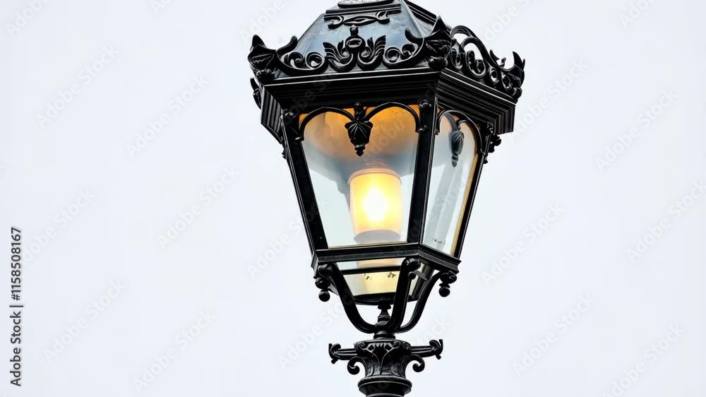 Decorative street lamp illuminating a cloudy sky in a peaceful urban setting during evening hours Decorative street lamp illuminating a cloudy sky in a peaceful urban setting during evening hours
