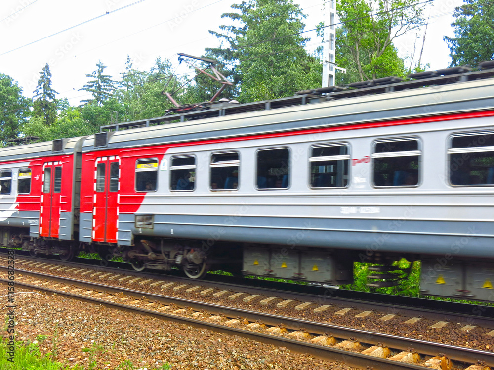 suburban train passes by a station near Moscow in the summer suburban train passes by a station near Moscow in the summer