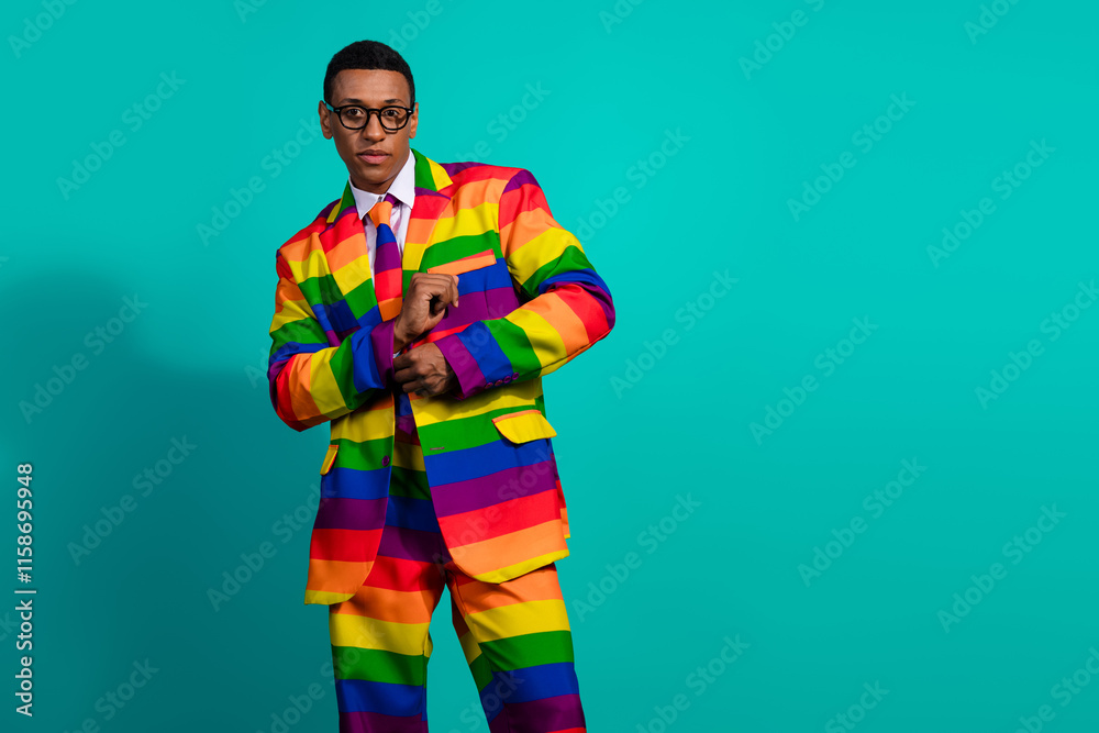 Confident man in rainbow suit against turquoise backdrop symbolizing individuality and freedom Confident man in rainbow suit against turquoise backdrop symbolizing individuality and freedom