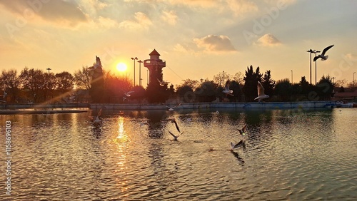 Photography Landscape of a lake at an autumn sunset with birds flying over it