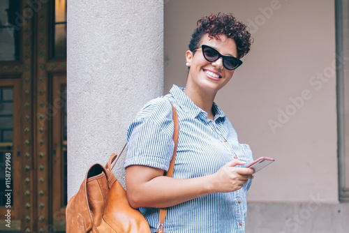 Satisfied visitor surfing smartphone in street